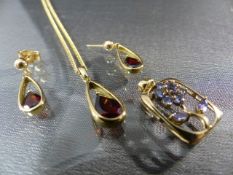 Gold - 8.1g of 9ct Gold in the form of Garnet earrings and pendant on 20" chain and a flower pendant