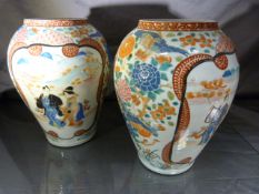 A Pair of Japanese vases highly decorated with stylised flowers and two panels to each vase