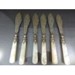 Set of six Art Nouveau Silver fish knives with mother of pearl handles. The blades etched with a