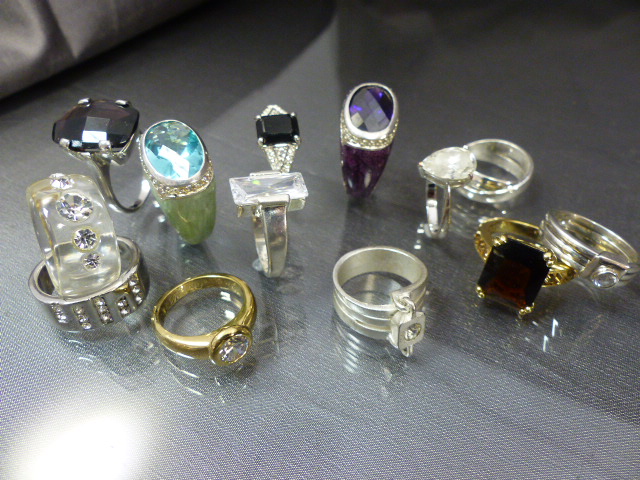 Thirteen costume rings to include some silver (Mostly M&S).