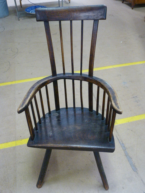 An Antique welsh comb back chair in Ash and poss Fruitwood with curved top rail. Thick odd shaped