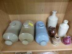 Box containing various stoneware hot water bottles