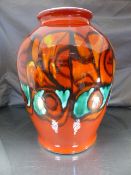 Large and impressive Poole Pottery Bulbous Delphis vase on a red ground with abstract design.