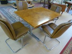 Pieff dining table with four tan leather chairs. The dining table raised on a chrome tubular frame