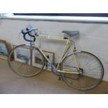 Vintage Motobecane Racing bike in good condition. Yellow on steel frame with gears and tyre pump.