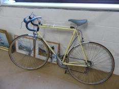 Vintage Motobecane Racing bike in good condition. Yellow on steel frame with gears and tyre pump.