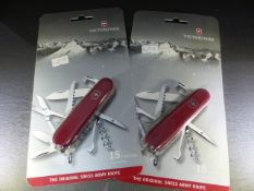 Two Victorinox 15 function original Swiss Army Knife in red. Unopened in casing.