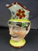 Early 19th Century Staffordshire jug with Bacchus head. The handle styled as a figure with
