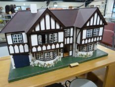 A Triang 'Stockbrokers' Tudor style dolls house, 1930s, grey painted triple apex roof, three