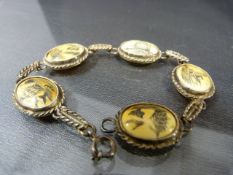 Five piece scrimshaw bracelet on hallmarked Birmingham silver mounts and links.