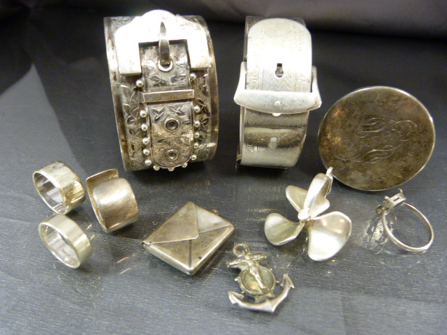 Collection of silver items to include lidded pot, two bangles, three rings a stamp holder etc. Total