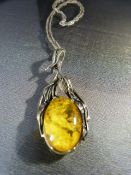 Arts and Crafts Silver necklace set with large oval Amber stone.