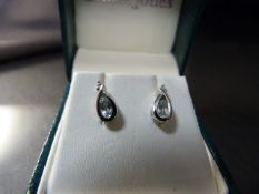 Pair of 9ct White Gold drop earrings set with a pale blue stone.