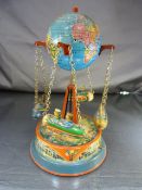 A lithograph tin plate merry-go-round with central globe and four little rockets hanging from chain.