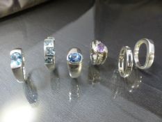 Six Hallmarked silver rings - 3 set with pale blue stones, 1 Amethyst, 1 x CZ and the other plain.