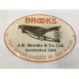 An older reproduction 'Brooks Saddles' oval enamel sign, 12 3/4 x 9".