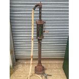 An early hand-operated petrol pump of plain form with early measuring system and a Bowser bronze