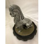 A car accessory mascot in the form of a sphinx, mounted on a radiator cap.