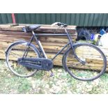 A Raleigh gentleman's bicycle with a Dunlop saddle and tool bag.