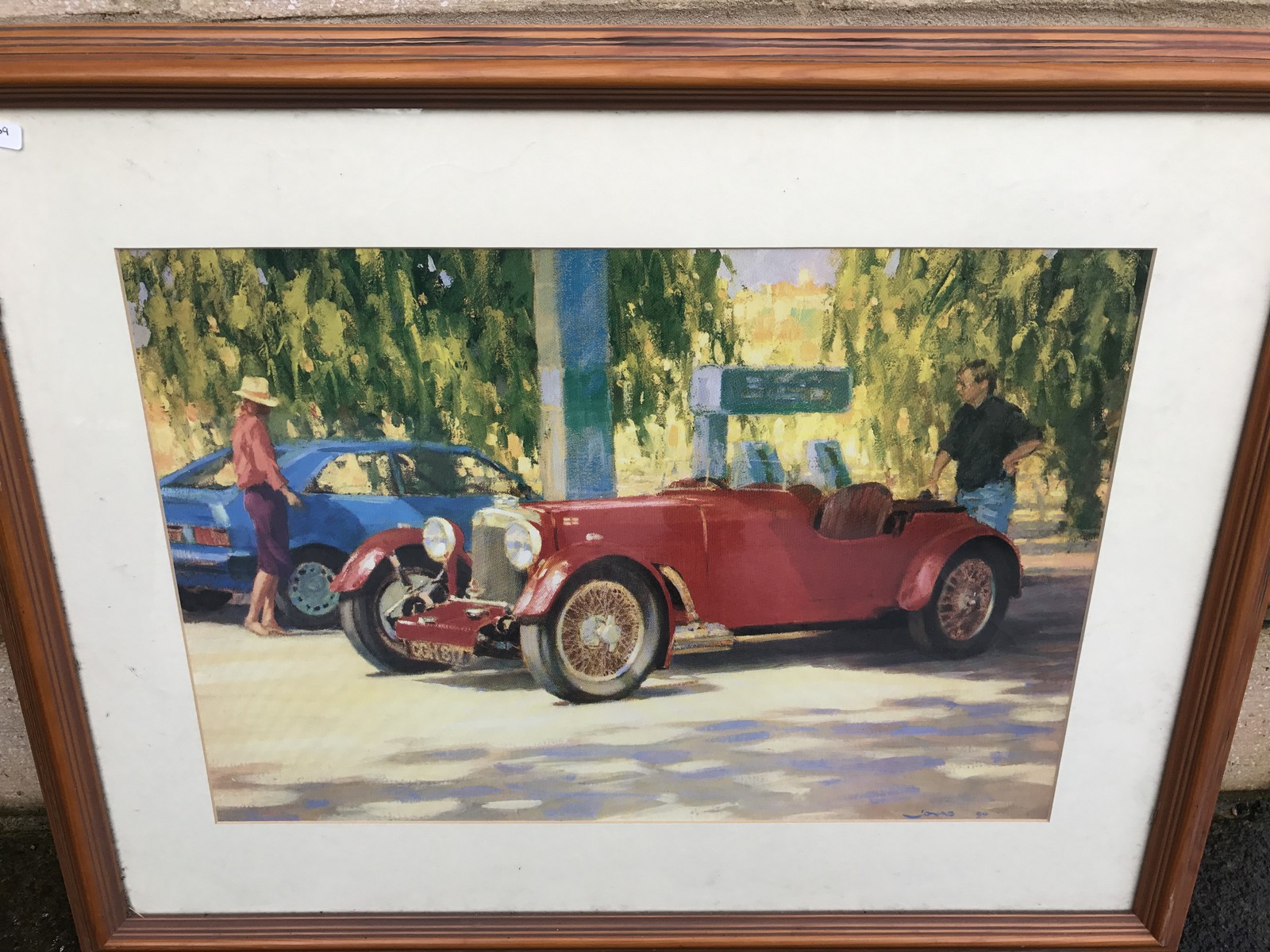 A framed and glazed print of a pre-war Aston Martin short chassis after a painting titled