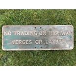 A rectangular aluminium road sign - No trading on highway, verges or laybys, 20 x 7".