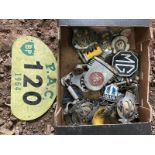 A box of assorted car insignia, badges etc.