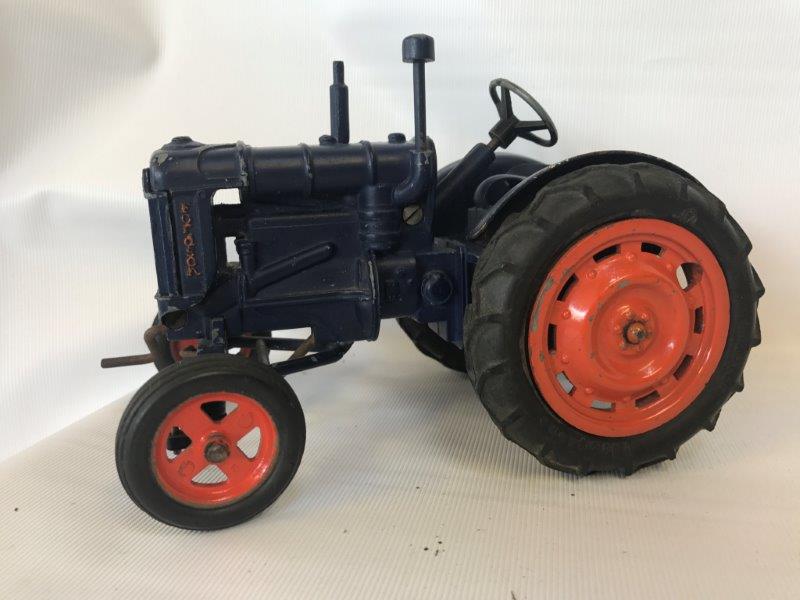 A Chad Valley Fordson diecast tractor.