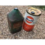 A Gulf five gallon cylindrical drum and a Castrol square five gallon drum.