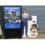 A garage forecourt Elf related advertising stand with poster showing Formula 1 racing drivers