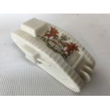 A crested ware porcelain model of a WWI tank, marked Cymru Am Byth, arms of Wales.