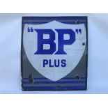 An early BP Plus enamel sign showing a white shield with blue lettering on a grey background, 21 x