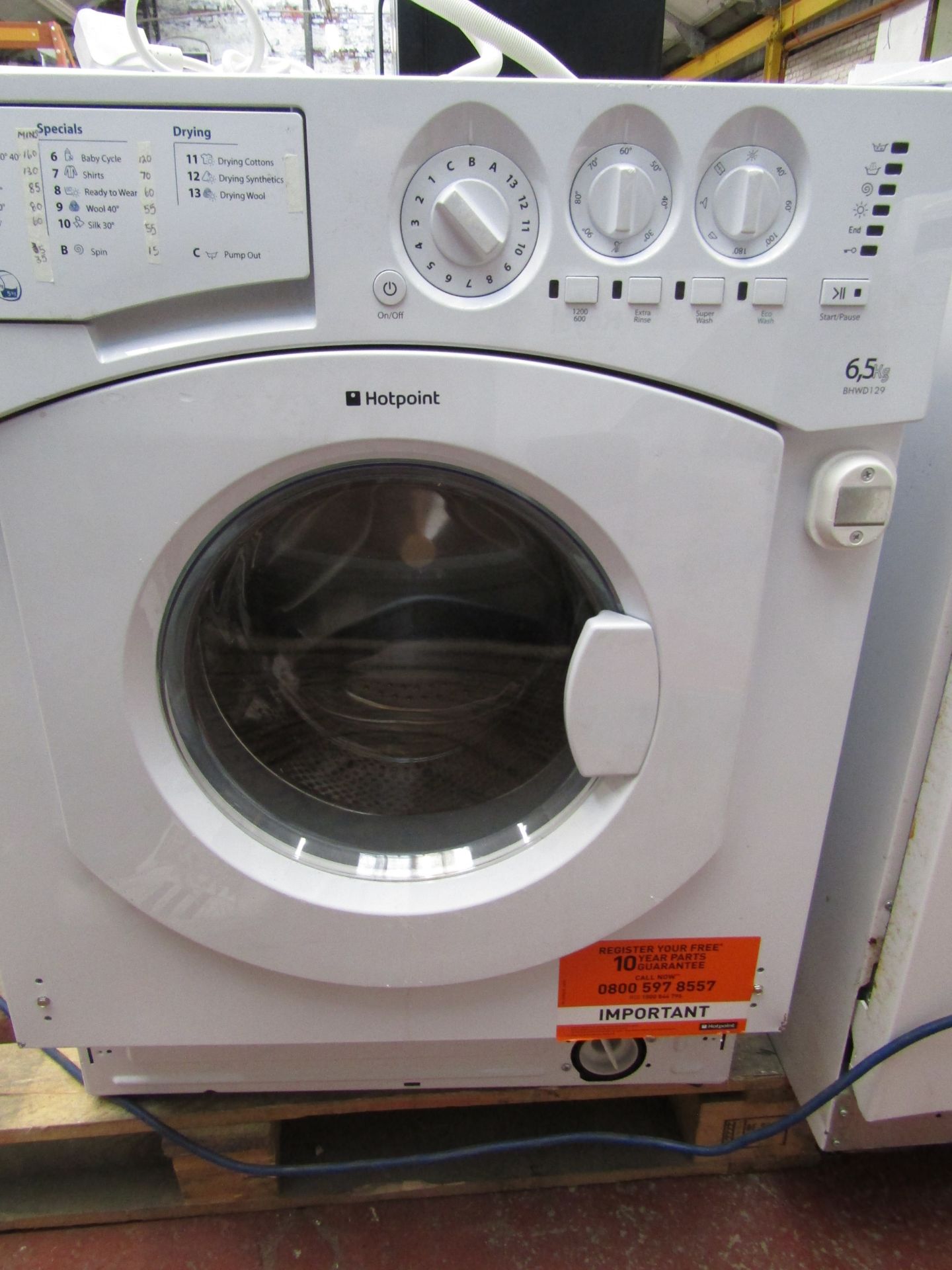Hotpoint 605KG integrated washing machine, powers up and spins, dented on side