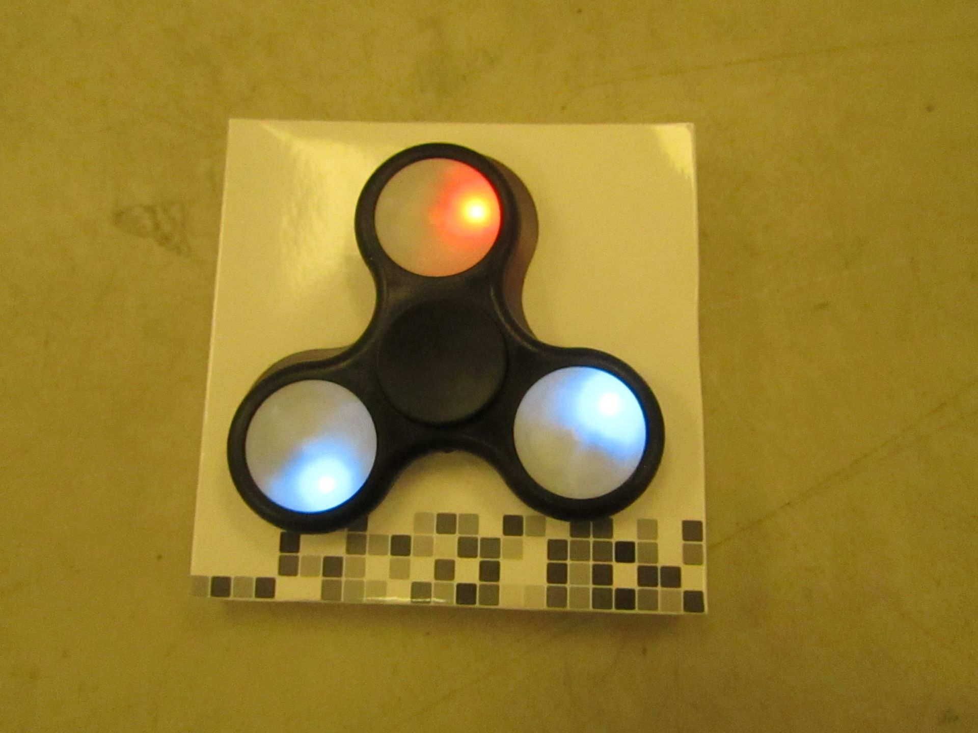 Light up fidget spinner with various light up effects, see picture for colour, new and boxed.