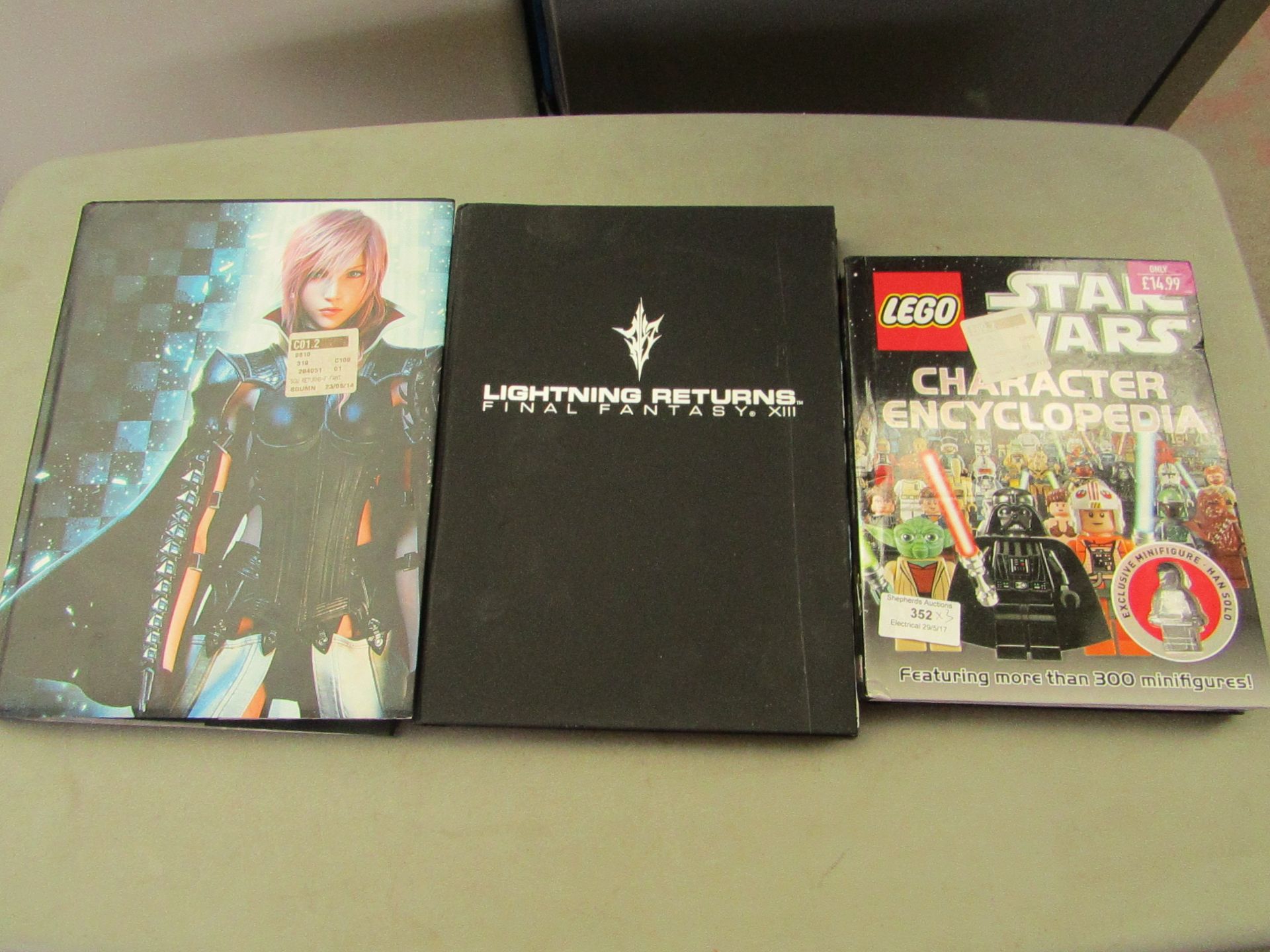 3x Gaming Books being, Lego Character encyclopedia and 2x Lightning returns Final Fantasy 13