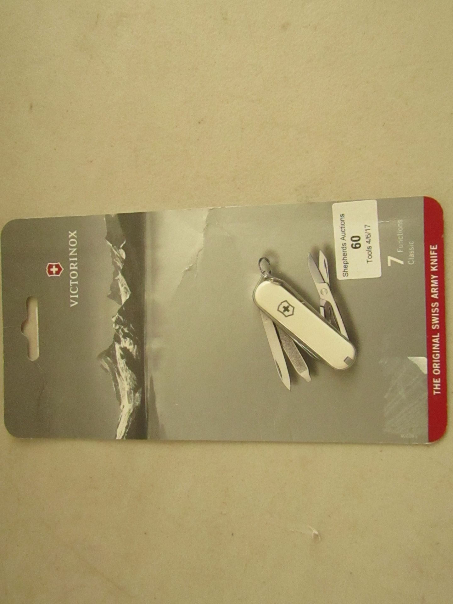 Victorinox original mini swiss army knife, white colour in packaging.