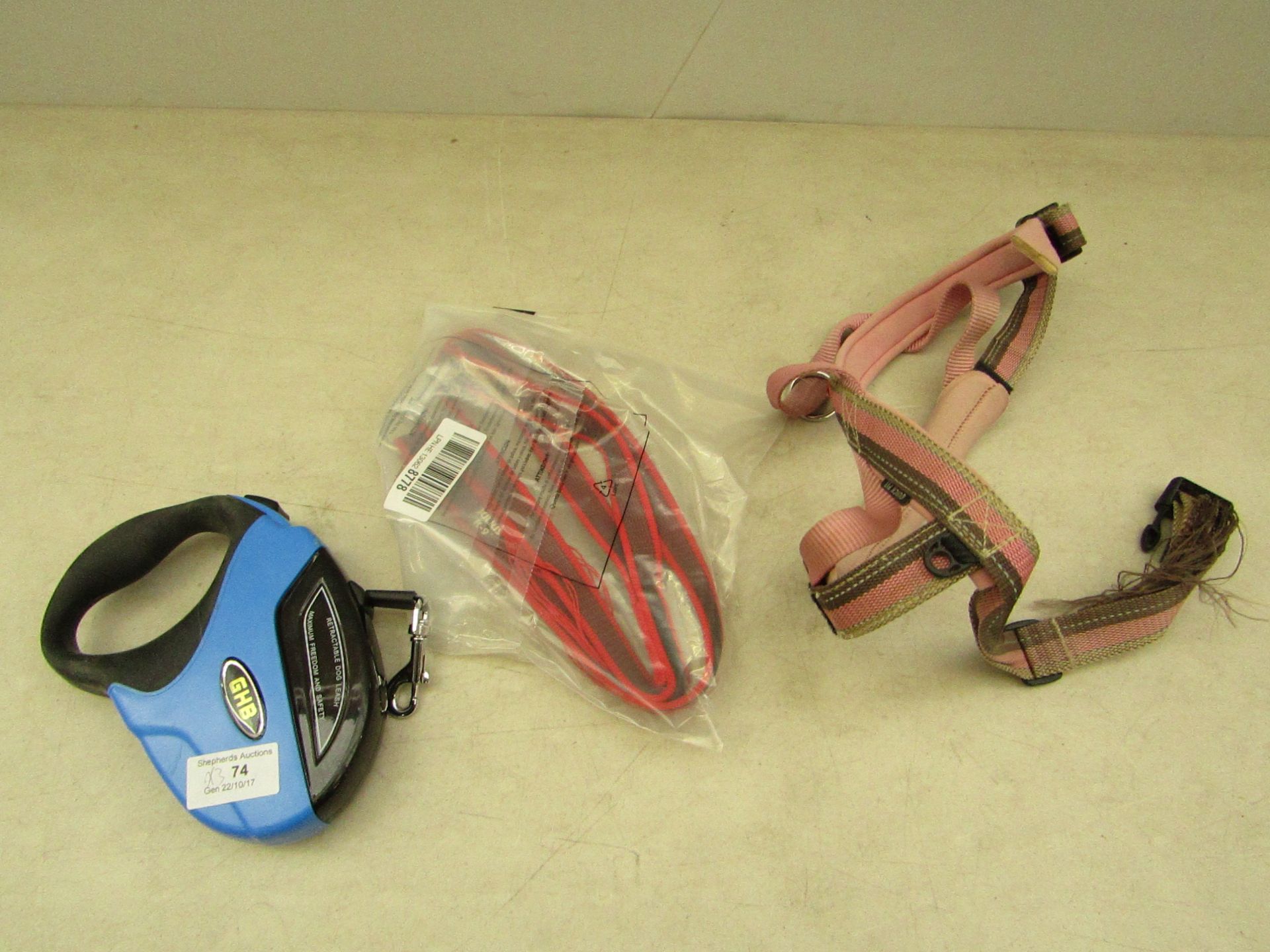 3x items being: - pink slightly damaged dog harness collar - blue retractable dog lead - red dog