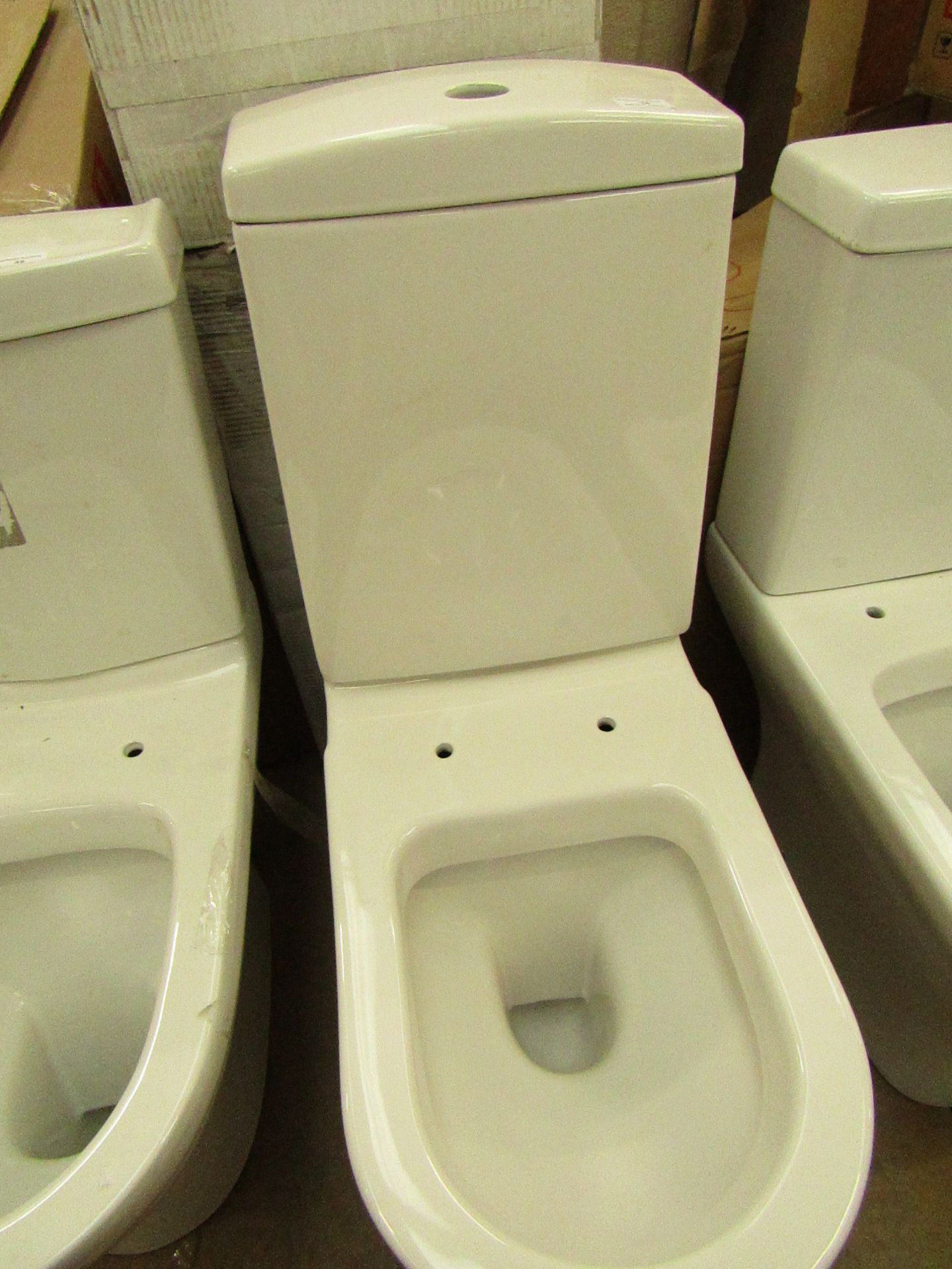 Close coupled toilet pan with cistern to match (with flush system). Boxed.