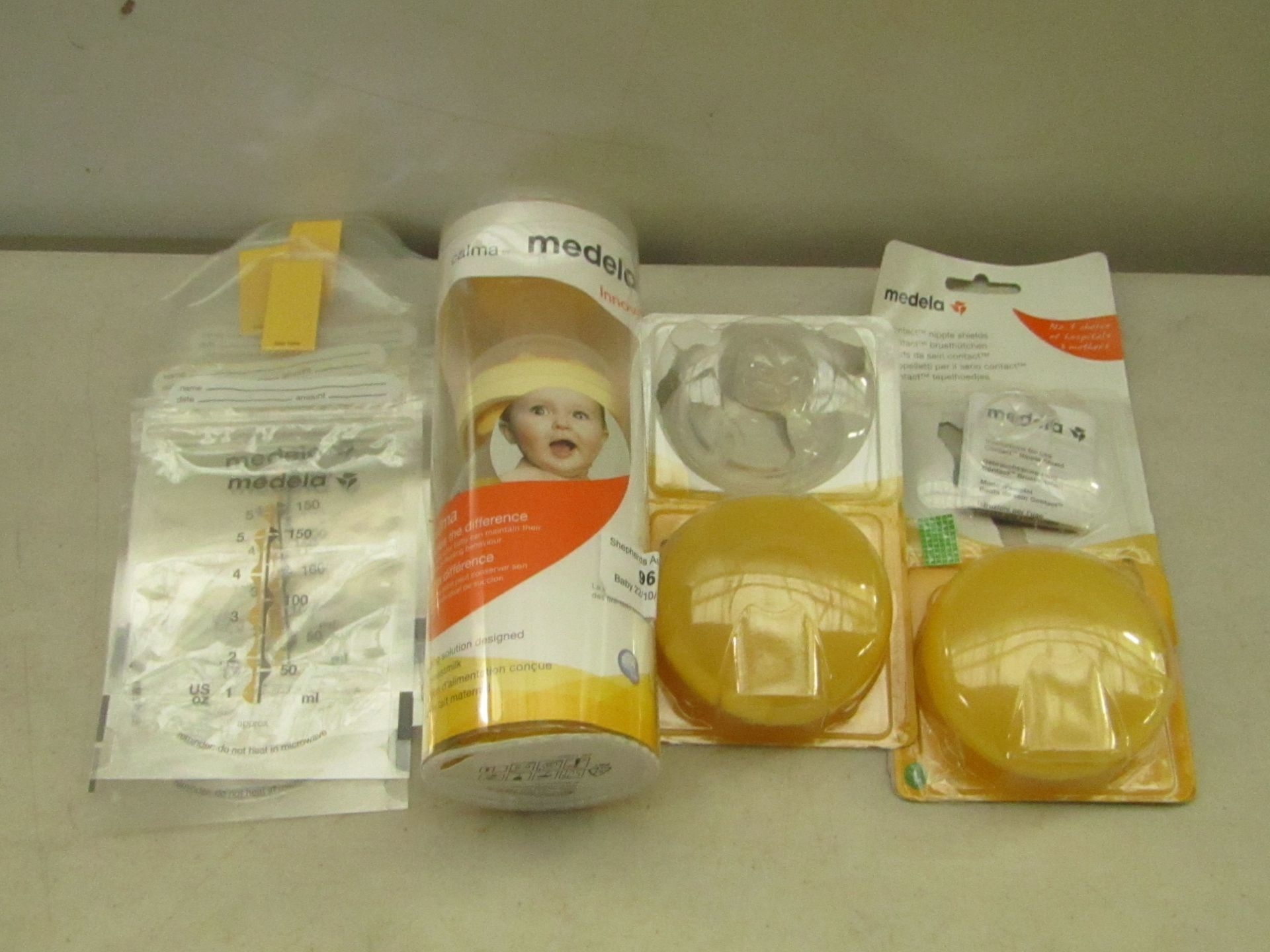 4x Medela Products being Calma feeding Bottle Nipple Shield, One Missing the rubber shield Approx