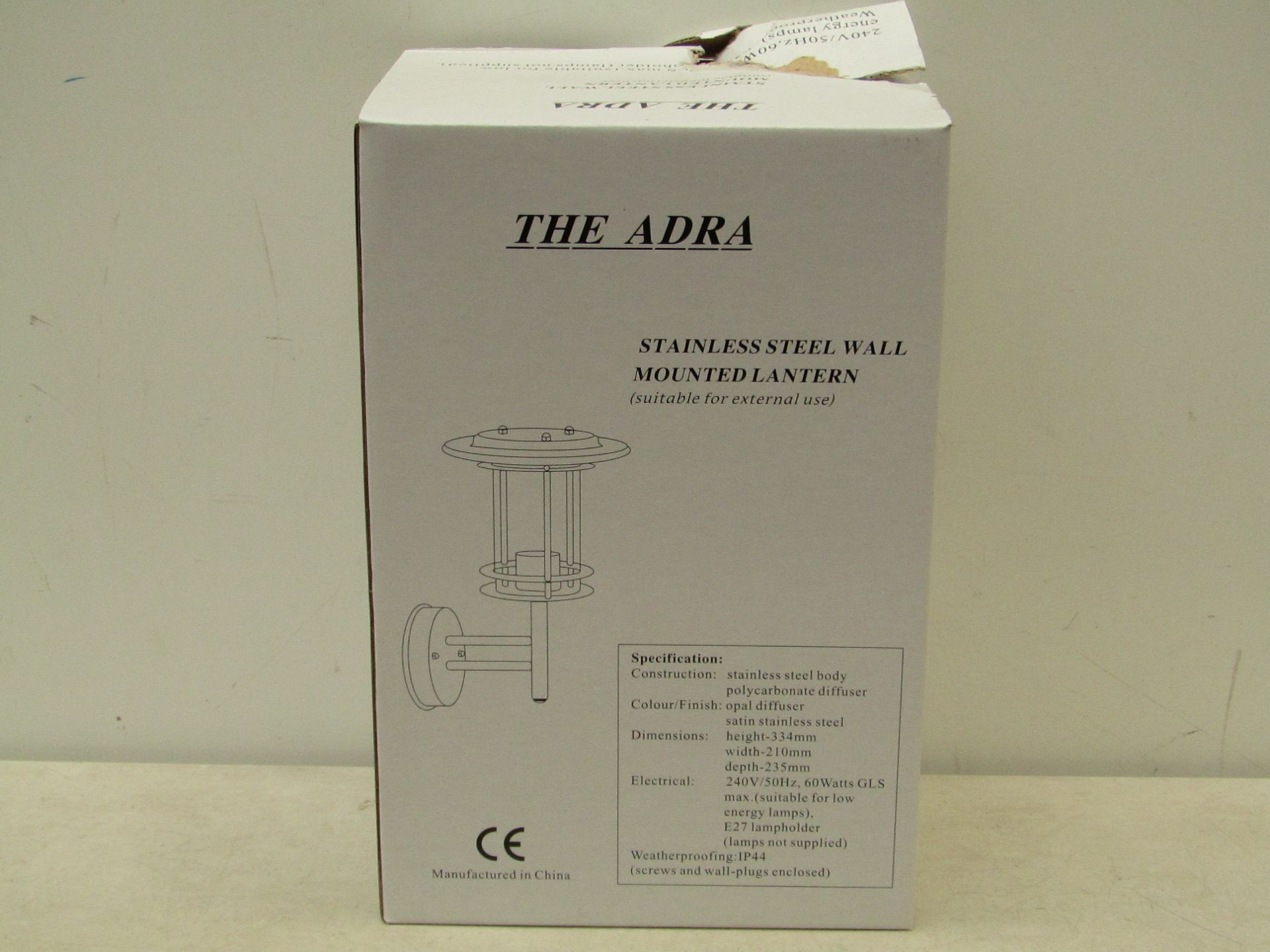 The Adra stainless steel wall mounted lantern (suitable for external use). Unchecked & boxed.