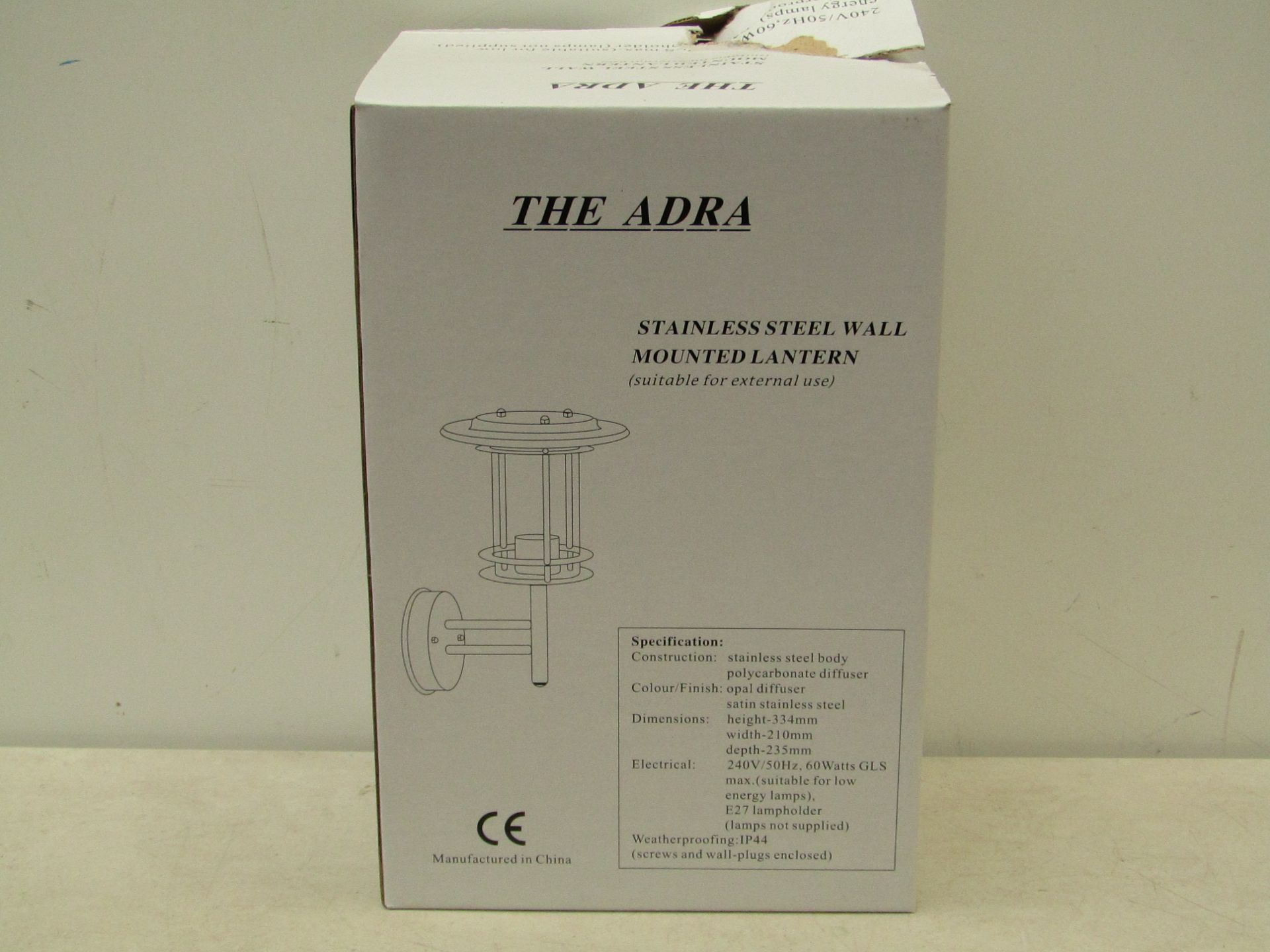 The Adra stainless steel wall mounted lantern (suitable for external use). Unchecked & boxed.