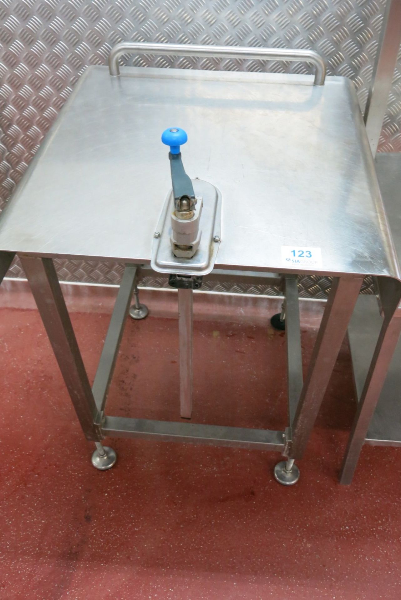 Stainless steel table with manual can opener