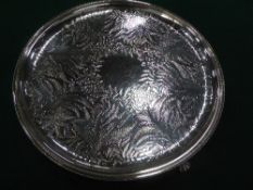 Silver plated circular tray decorated with ferns, on 3 claw feet, 12.5' diameter