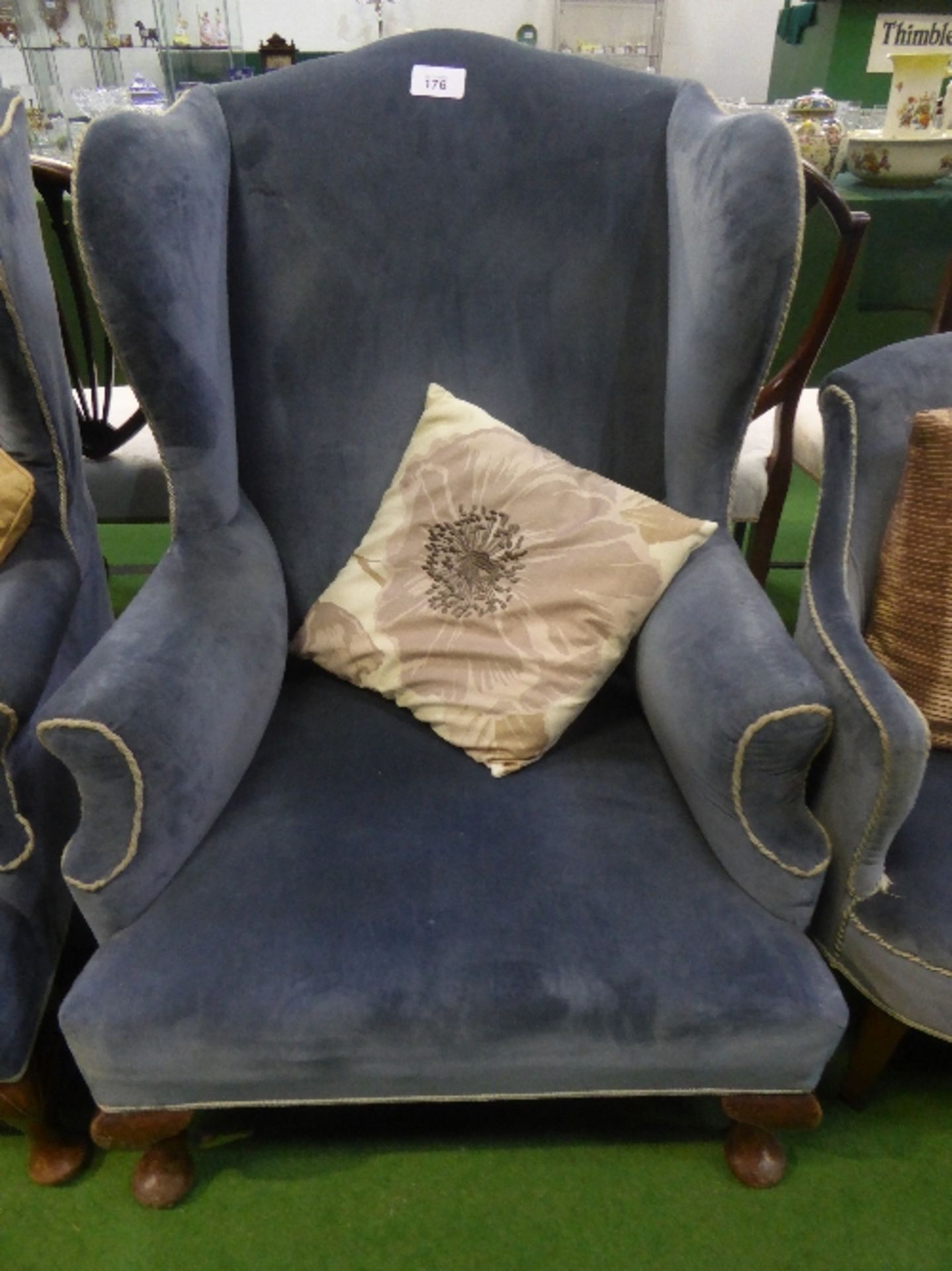 Blue velour-type upholstered wing back chair on pad feet