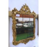 Carved gilt wood wall mirror in framed scroll eagle surmount, overall 36' x 22'