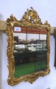 Carved gilt wood wall mirror in framed scroll eagle surmount, overall 36' x 22'