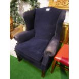 Blue upholstered wing back armchair