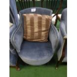 Blue velour-type tub chair on castors