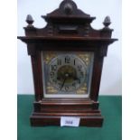 Oak cased mantel clock with polished shell & brass face, c/w key
