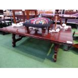 Chestnut occasional/coffee table on shaped support & wrought iron brackets, 58' x 38'