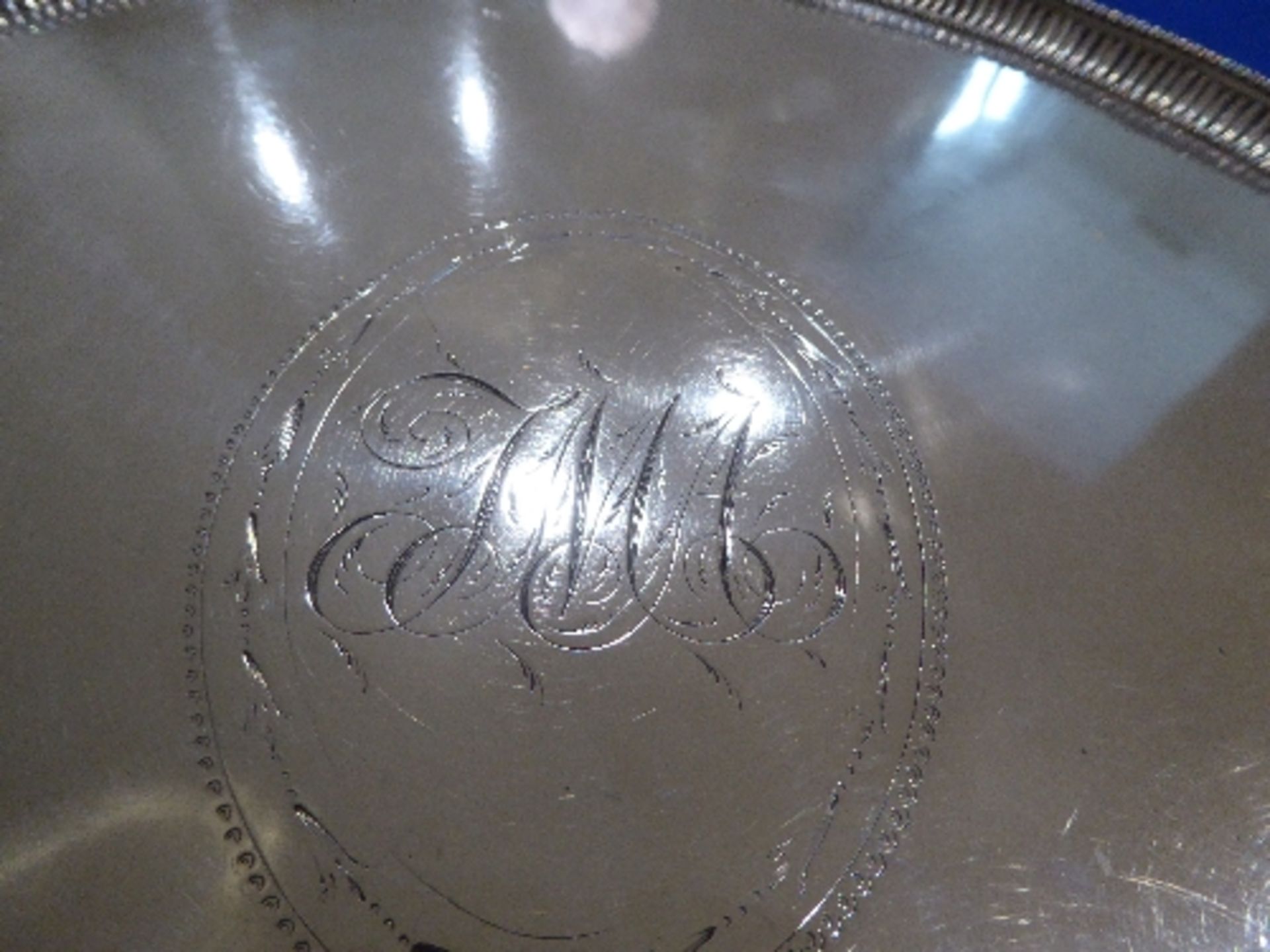 Georgian silver circular tray, 31cms diameter, on 3 feet, with beaded edge and initials engraved